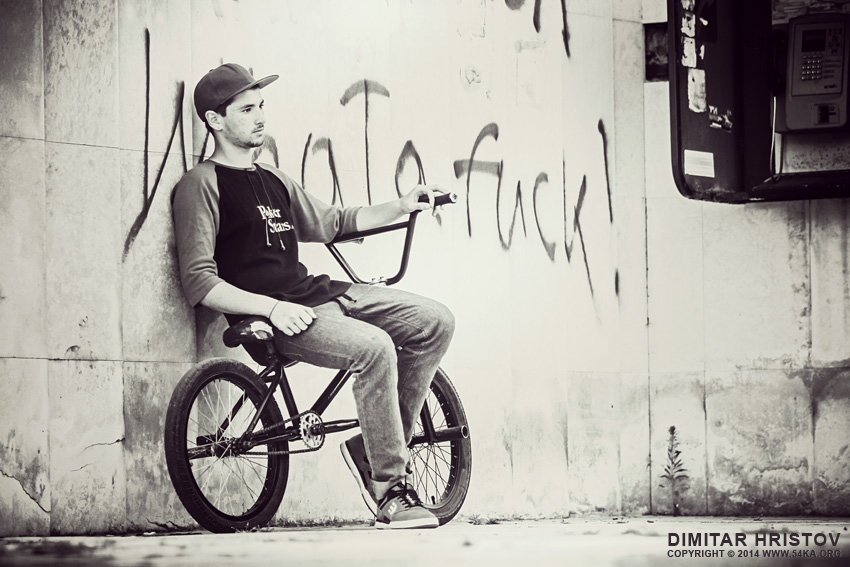 Portrait of the bicyclist sitting on BMX photography portraits black and white  Photo
