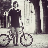 The young male bicyclist with BMX bicycle