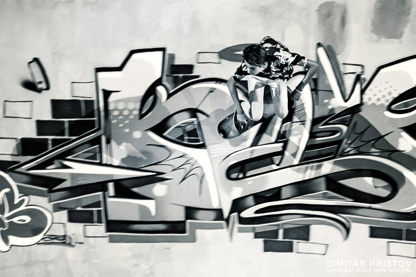 Boy riding skateboard in graffiti drawing pool photography extreme black and white  Photo