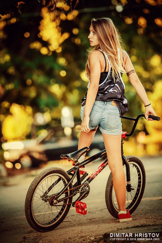 Lovely young woman riding a BMX bicycle photography portraits extreme  Photo