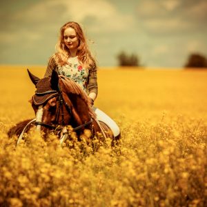 Girls riding horse in beautiful meadow