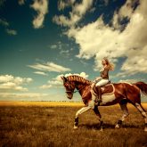 Girl riding horse on the beautiful landscape