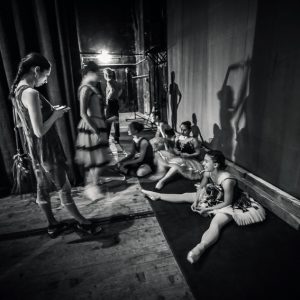 Ballerinas sitting on the warm-up backstage
