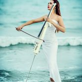 Woman playing cello in the sea