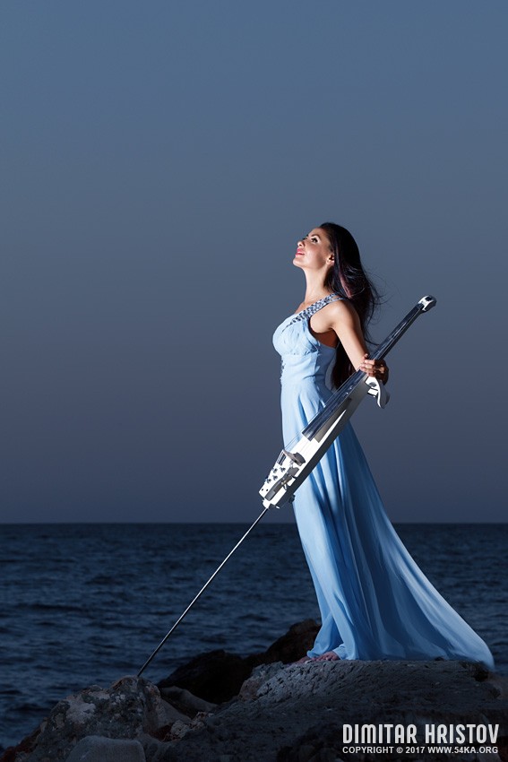 Beautiful woman with a cello on beach photography portraits featured  Photo