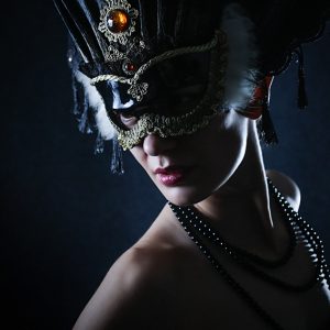 Beauty model wearing venetian masquerade carnival mask