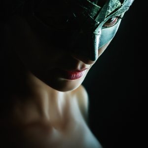 Beauty model woman wearing venetian masquerade carnival mask – dark background
