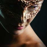 Beauty glamour woman wearing in venetian masquerade carnival mask.