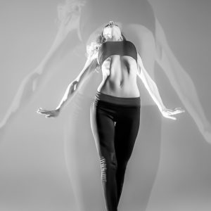 Modern style dancer dancing on a studio gray background