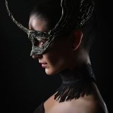 Portrait of girl with fashion dragon eye mask