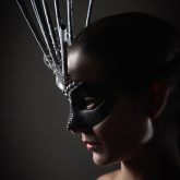 Portrait of young girl with conceptual carnival mask