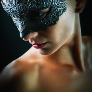 Studio portrait of a girl with beautiful dark mask
