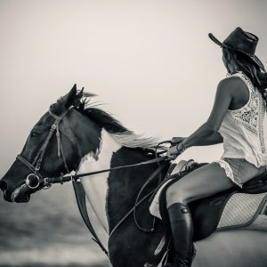 Woman riding horse on the coastline